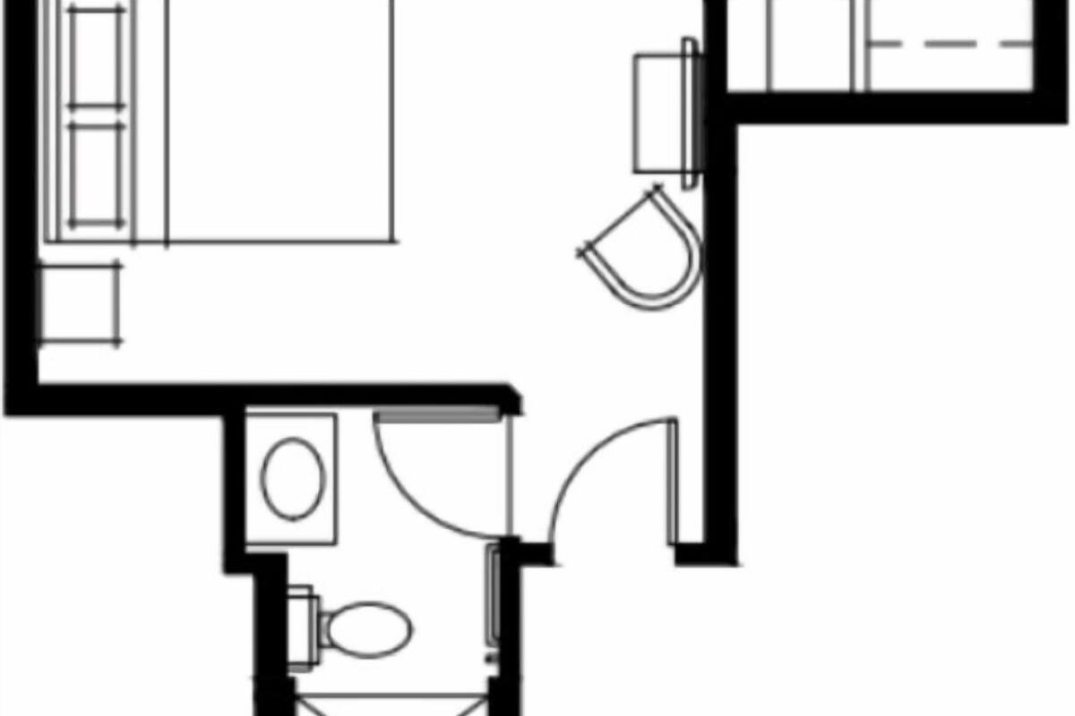 A floor plan with a bedroom, bathroom, and kitchenette.