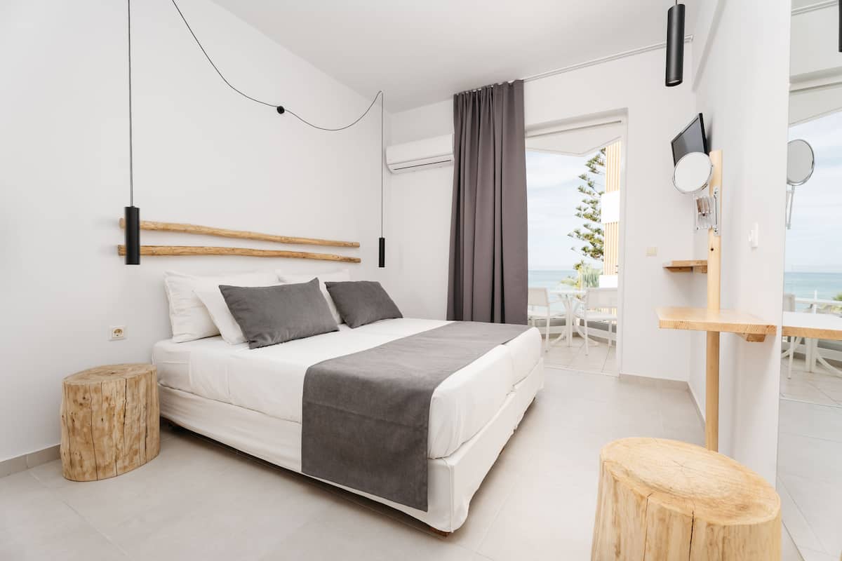 Een moderne slaapkamer met een bed, nachtkastje en uitzicht op de omgeving.