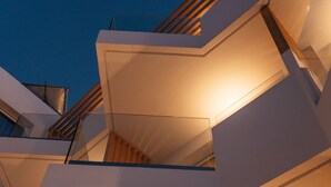A modern multi-level residential building with a staircase and a window.