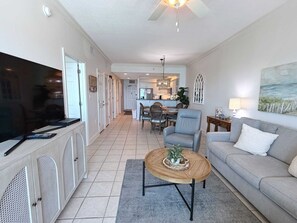 A living room with a television, sofa, and coffee table.