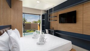 A modern hotel room with a bed, a TV mounted on the wall, and a view of a swimming pool.