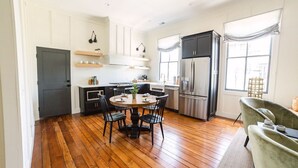A modern kitchen with a dining area, wooden flooring, and built-in appliances. - EAST 46 G - 1 Block to King! (Charleston)