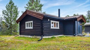 A log cabin with two windows, a chimney, and a small porch. - Nice home in Kvam with kitchen (Kvam)