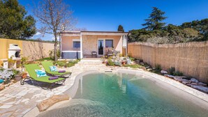 A house with a stone exterior, a patio with a pool, and a wooden fence. - Amazing home in Peroj (Peroj)
