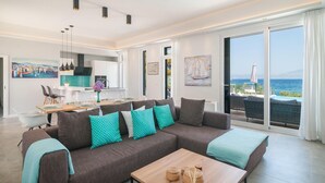 A modern living room with a sofa, coffee table, and dining area with chairs and a table set for a meal. - Luxurious home in Sutivan (Sutivan)