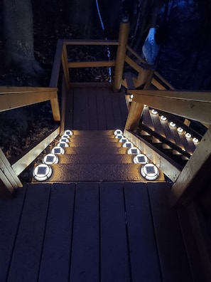 Stroll along the deck's inviting pathway, lined with soft lighting and bordered by railings.