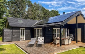 Enjoy a spacious deck with a dining table and lounge chairs, perfect for outdoor relaxation.