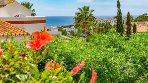 A coastal view with buildings, palm trees, and a clear sky. - Nice home in La Cala de Mijas (La Cala de Mijas)