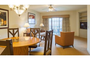 Enjoy meals in the dining area with a table set for two and comfortable seating.