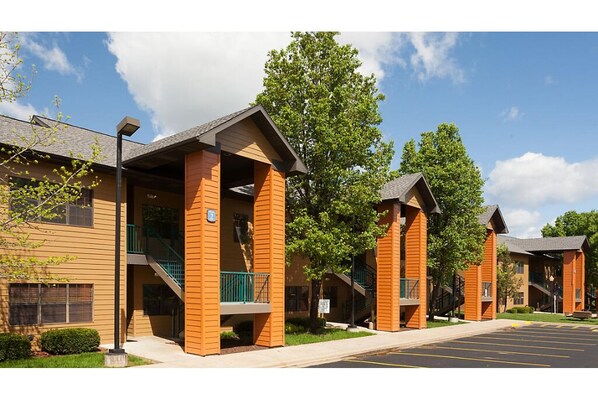 Stylish buildings with balconies and staircases, set amidst a flat landscape.