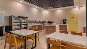 A modern cafe with white tables and wooden chairs, a coffee machine, and a refrigerator with glass doors. - Greentree Inn Beijing Daxing District Huangcun Wes (Daxing)