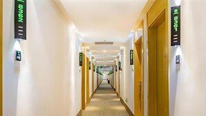 A hotel hallway with doors numbered 8361 and 8362, featuring a carpet with circular patterns and a neutral color scheme. - Greentree Inn Beijing Daxing District Huangcun Wes (Daxing)