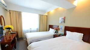 A hotel room with two beds, a desk with a chair, a TV, and a window with curtains. - Greentree Inn Jiangsu Changzhou South Changwu Road (Changzhou)