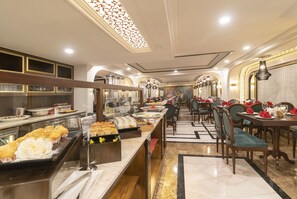 A buffet area with various food items and a long counter.