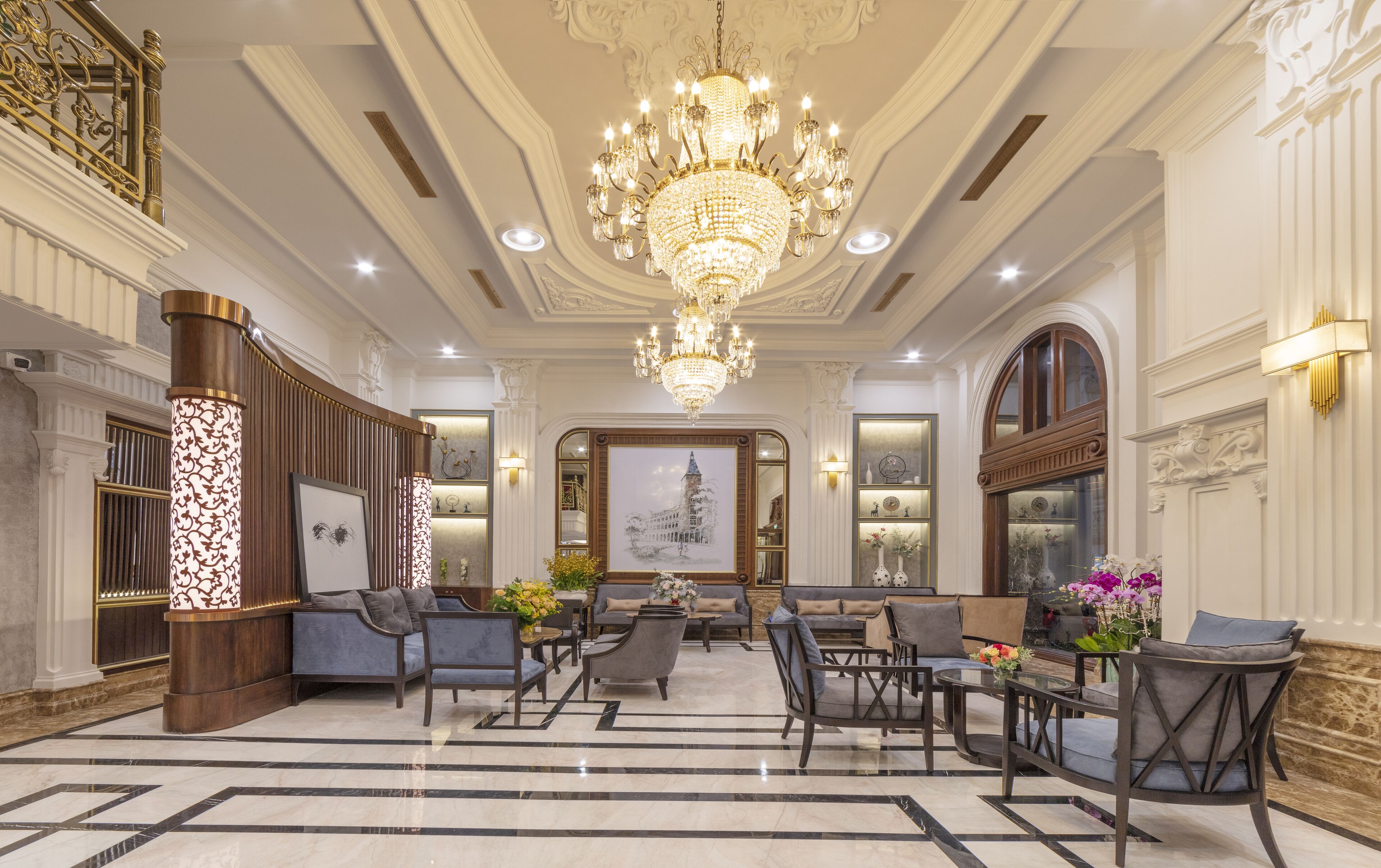 A grand lobby with a large chandelier, elegant furniture, and a marble floor.