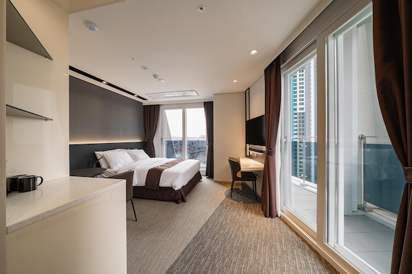 Premium bedding, desk, laptop workspace, iron/ironing board