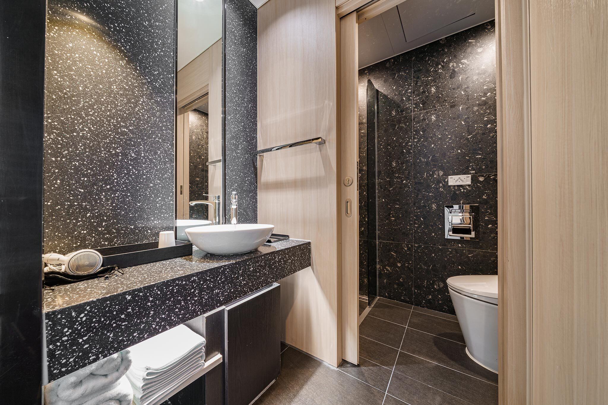 deluxe double room | bathroom | shower, rainfall showerhead, hair dryer, bathrobes