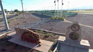 A memorial plaque and a rotary park sign. - A Beautiful Colorado River Retreat (Bullhead City)
