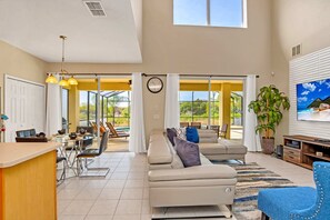 Relax in this stylish living area with a comfortable sofa, dining table, and kitchen counter.