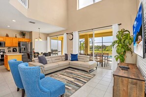 Relax in this inviting living area with a large sofa, coffee table, and comfortable chair.