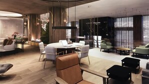 Een modern interieur met een ronde tafel, zitplaatsen en een open haard.