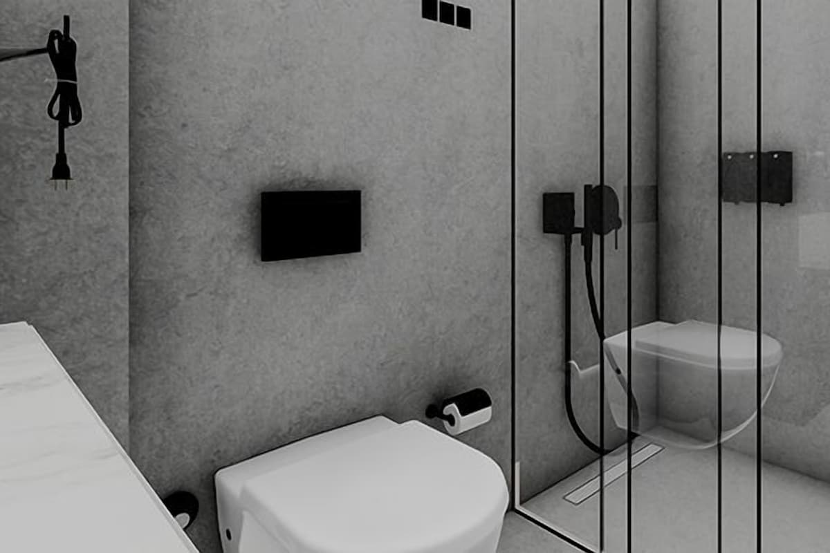A modern bathroom with a toilet, bidet, and shower.