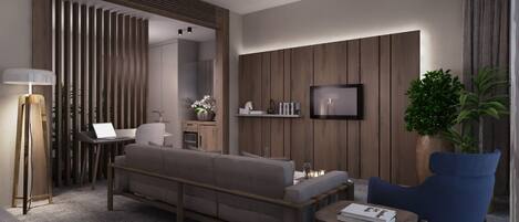 A modern living room with a sofa, a coffee table, a blue armchair, a floor lamp, a TV, and a plant.