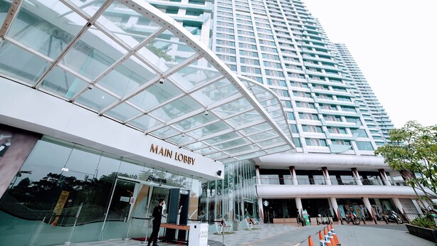 A modern building with a glass facade and a sign reading "MAIN LOBBY".