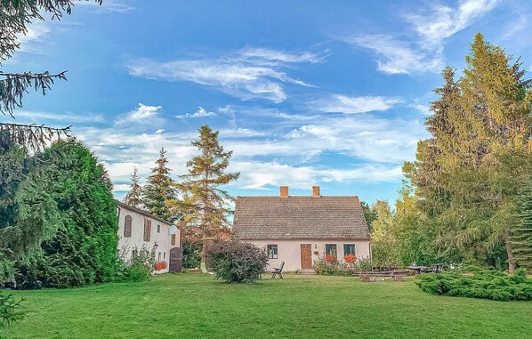 Surrounded by mature trees, this traditional home offers a serene retreat with a well-maintained yard and a small garden area.