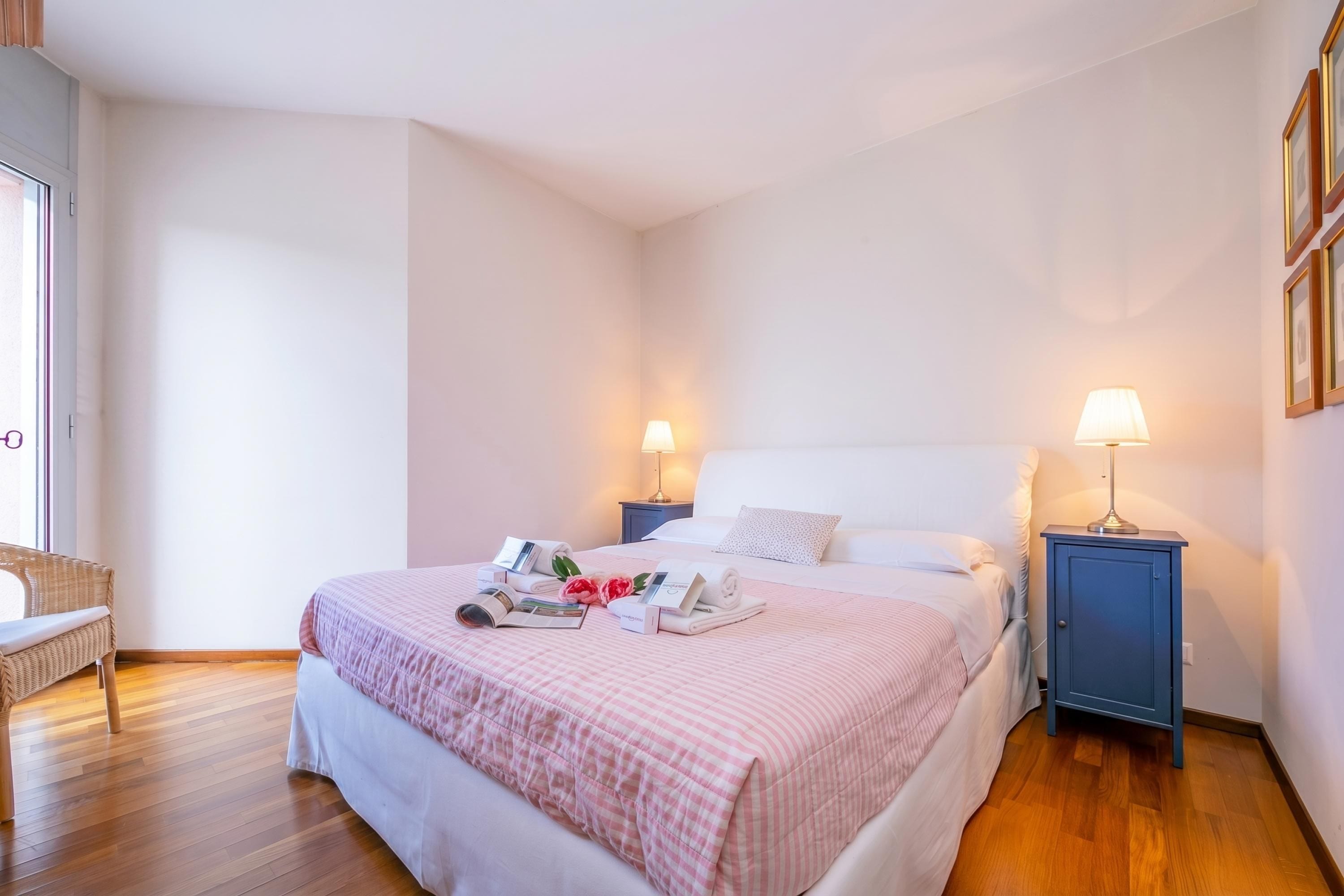 A neatly arranged bedroom with a bed, bedside tables, and a bench.