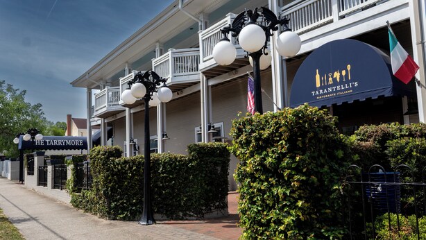 A building with a sign for 'Tarantelli's Ristorante Italiano' and another sign for 'The Tarrymore.' - Prime downtown location, luxury condo getaway  (Wilmington)