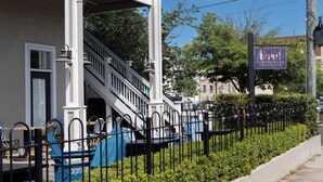 A building with a staircase, outdoor seating, and a sign for Tarantelli's Italian restaurant. - Prime downtown location, luxury condo getaway  (Wilmington)