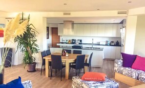 Cozy living space with a central dining area, kitchen, and comfortable seating.