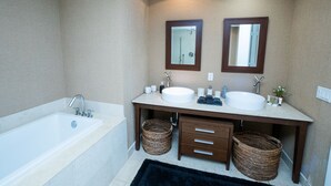A bathroom with a bathtub, two sinks, wooden vanity, wicker baskets, and mirrors. - Breathtaking view (Miami)