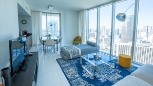 A modern living room with a sofa, coffee table, and city view. - Breathtaking view (Miami)