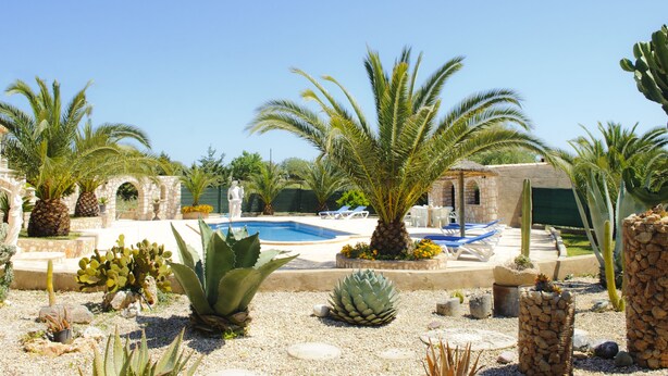 A pool area with palm trees, cacti, and a stone building. - Beautiful house for 6 people with pool, just a few minutes' drive to the beach (S' Horta)