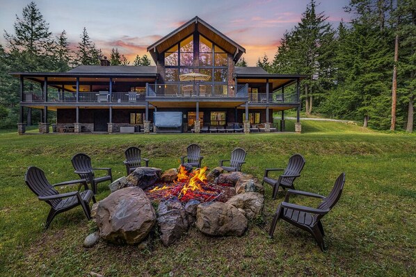 A large lodge with a fire pit and outdoor seating. - 1PM In/Out Memories Are Made Here, 6,200 Sq Ft with Spa & Chef's Kitchen (Ronald)