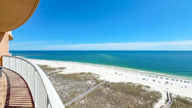 A balcony with a view of a beach and ocean. - New Complex!  Lazy River/Slide, Beachfront! (Orange Beach)