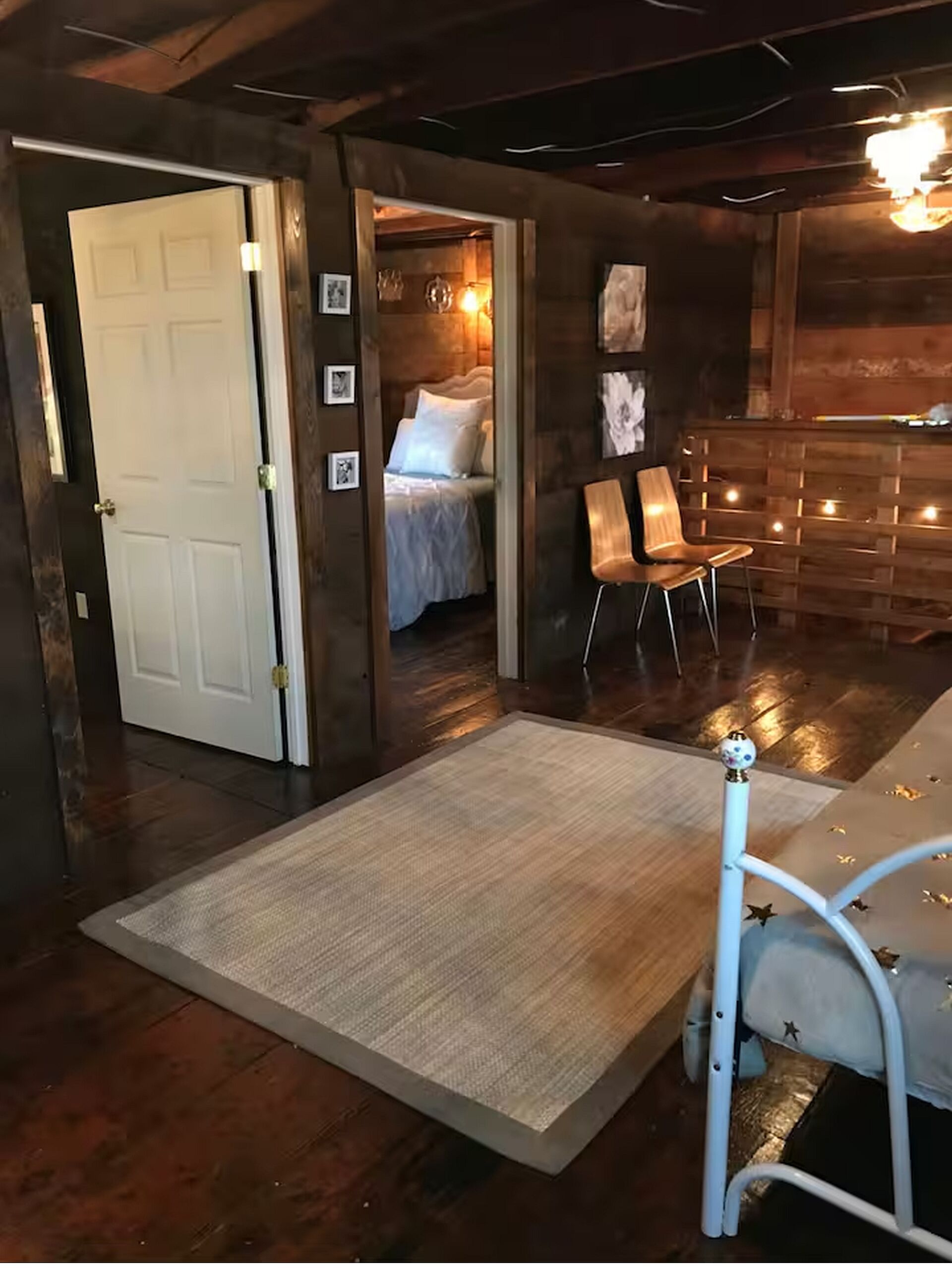A cozy room with a bed, a chair, and a small table.