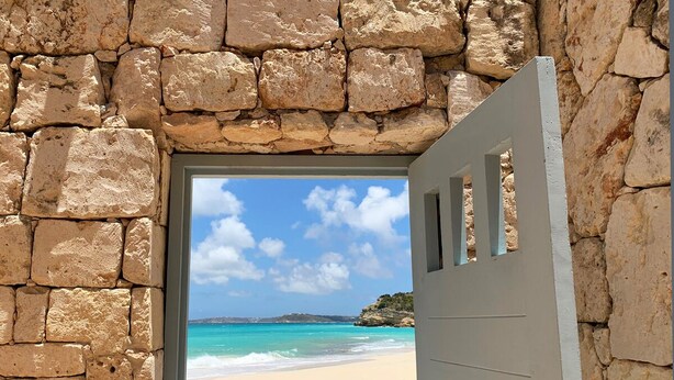 A stone wall with a door leading to a beach. - Santosha Villa Estate, Private Staffed Beach Resort All to Yourself, Sleeps 21 (Long Bay Village)