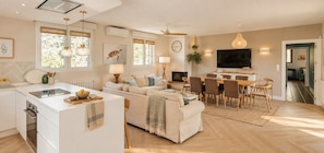 A modern living space with a kitchen, dining area, and seating area. - Finca Aprisco de Candeleda, a dream to share. (candeleda)