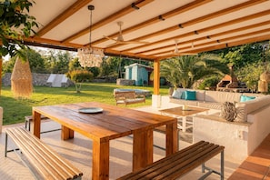 An outdoor patio with a wooden table, benches, a swing, and a sofa. - Finca Aprisco de Candeleda, a dream to share. (candeleda)