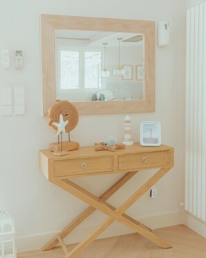 A wooden vanity with a mirror, a starfish decoration, and a small lighthouse model. - Finca Aprisco de Candeleda, a dream to share. (candeleda)