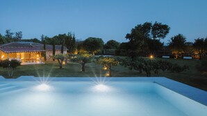 A swimming pool with a house in the background.