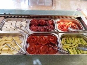 A buffet with various food items including sliced meats, cheeses, and vegetables. - Hotel Cinema (Primorsko)