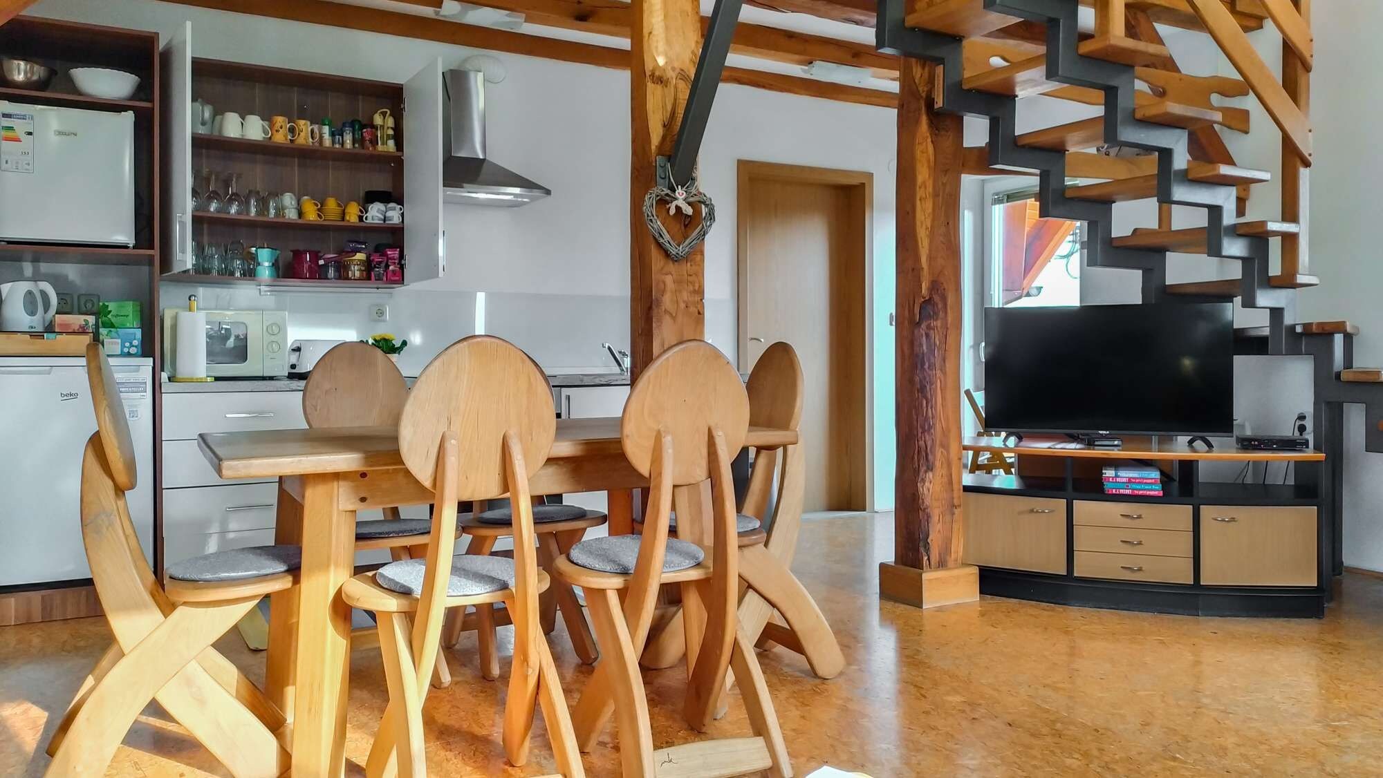 A modern kitchen with wooden cabinets, a built-in oven, and a microwave.
