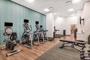 A fitness center with treadmills, elliptical machines, and a bench. - Holiday Inn Express & Suites Lincoln Downtown by IHG (Lincoln)