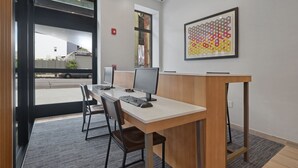 A modern office space with a desk, two monitors, and a chair. - Hotel 1200 (Brooklyn)