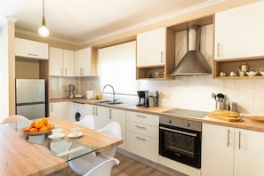 Fridge, coffee/tea maker, electric kettle, dining tables