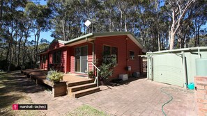 Enjoy a serene stay in a single-story house surrounded by a natural forest setting.